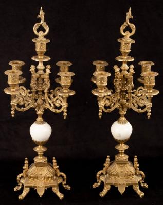 Appraisal: A pair of four-branch brass candelabra the stems with white