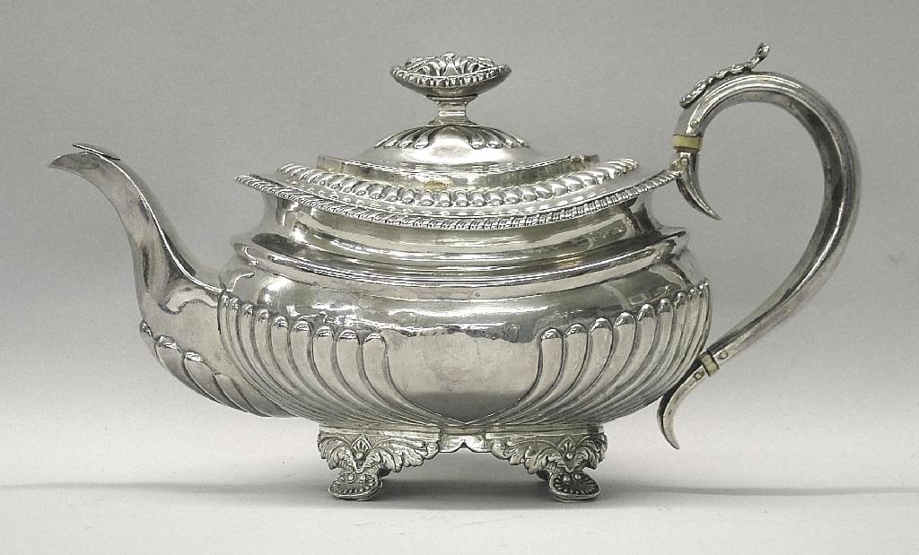 Appraisal: George III oval teapot of half fluted form with gadrooned