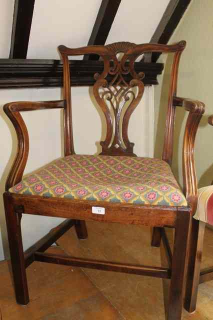 Appraisal: A GEORGE III MAHOGANY ELBOW CHAIR with carved splat back