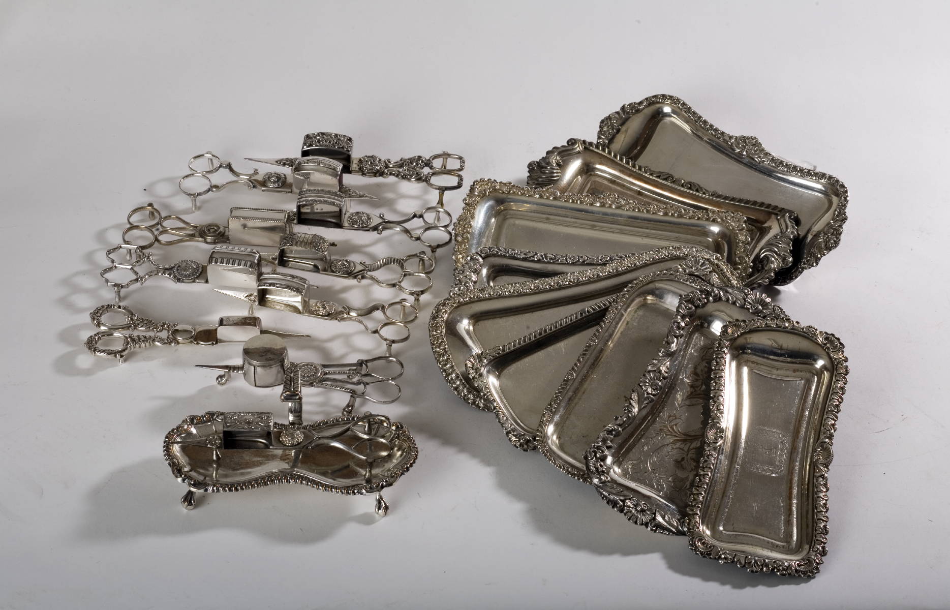 Appraisal: TEN ENGLISH SILVERPLATE CANDLE SNUFFERS AND TRAYS Length of largest