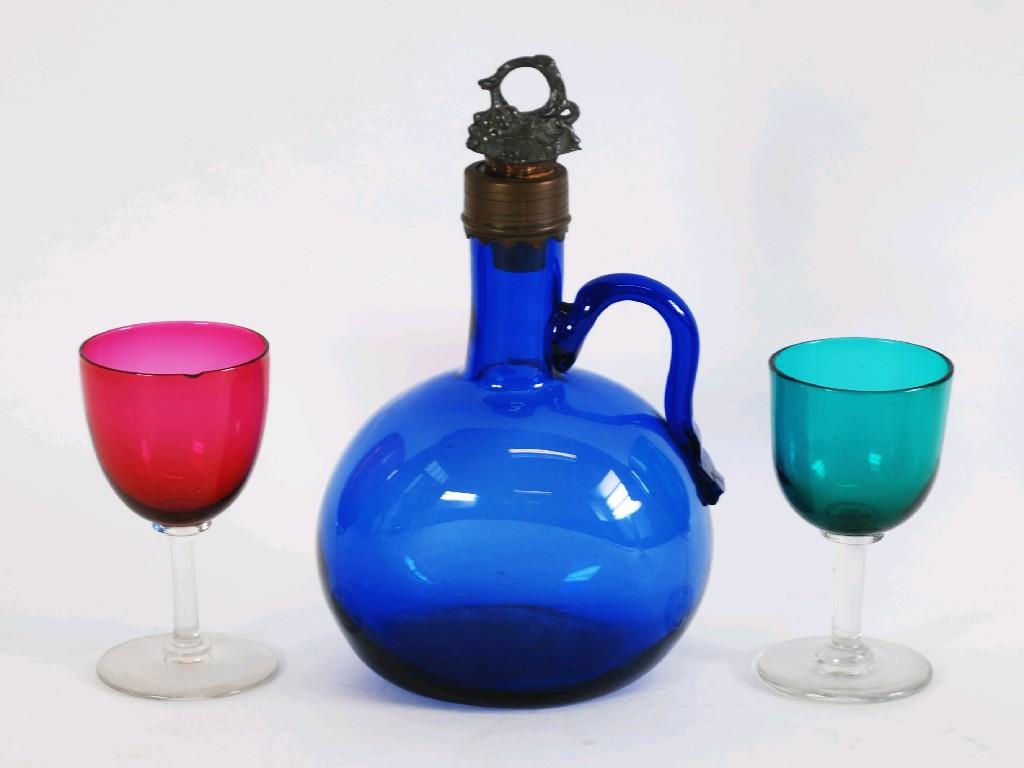 Appraisal: ANTIQUE BRISTOL BLUE GLASS WINE JUG with metal mounted rim