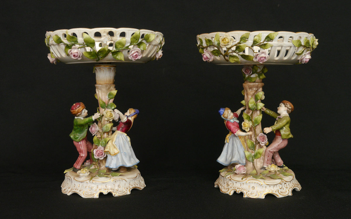 Appraisal: PAIR GERMAN POECELAIN FIGURAL COMPOTES Reticulated removable top with applied