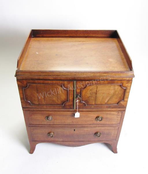 Appraisal: A Georgian style mahogany commode with pull-out surface with tooled