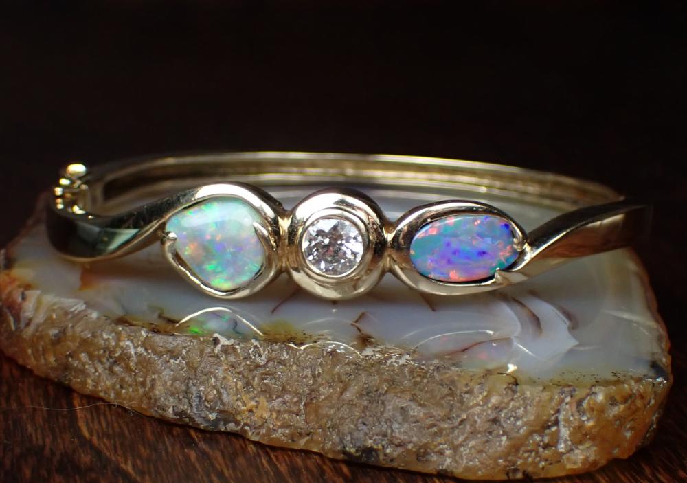 Appraisal: DIAMOND OPAL AND FOURTEEN KARAT GOLD BANGLE The oval hinged