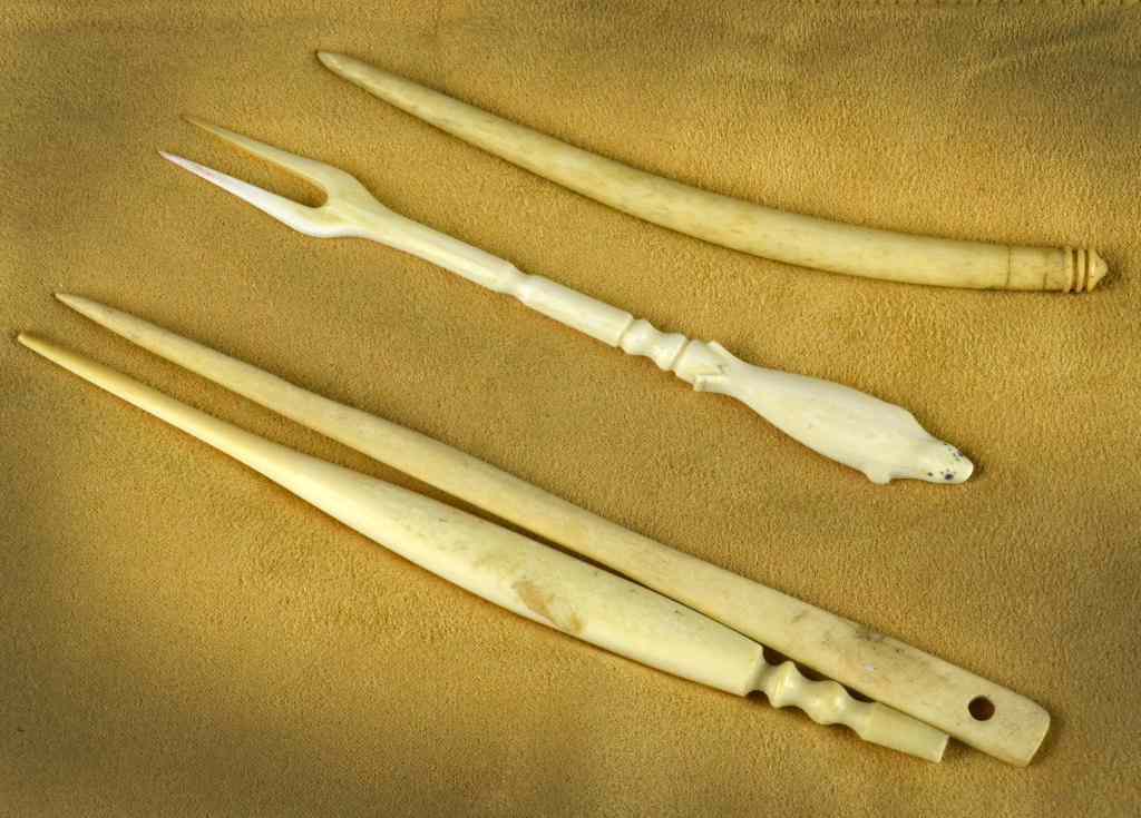 Appraisal: Walrus Tusk ToolsEach finely carved and retaining a wonderful old