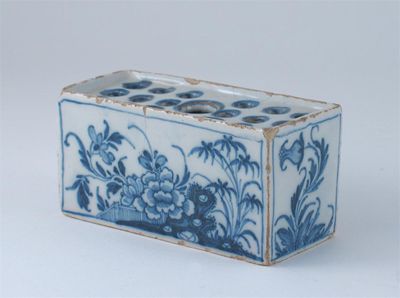 Appraisal: A Delftware small rectangular flower brick painted in blue with