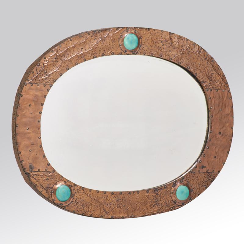 Appraisal: ENGLISH ARTS AND CRAFTS Wall mirror Mirrored glass hammered copper