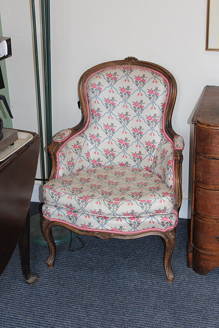 Appraisal: A PAIR OF FRENCH CARVED WALNUT ARMCHAIRS with overstuffed upholstered