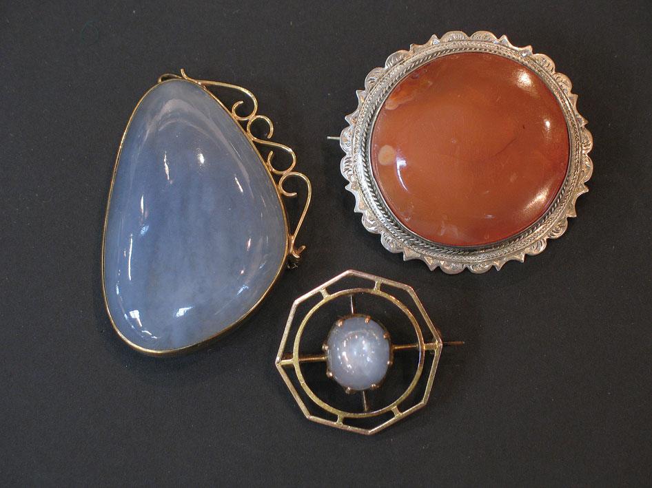 Appraisal: TWO ARTS AND CRAFTS STYLE MOONSTONE BROOCHES one set in