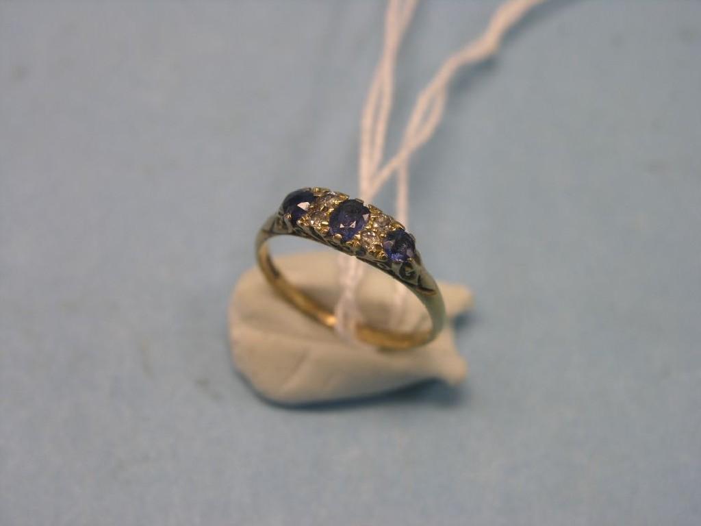 Appraisal: An ct gold half-hoop ring three sapphires and diamond chips