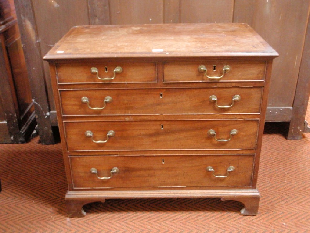 Appraisal: A George III cross banded mahogany chest of two short