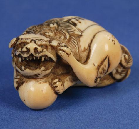 Appraisal: A JAPANESE IVORY NETSUKE in the form of a crouching