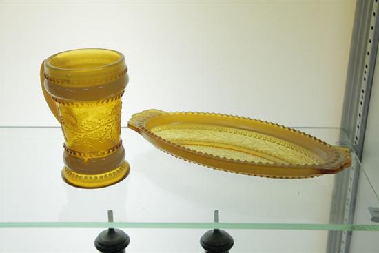 Appraisal: TWO PIECES OF HOLLY AMBER GLASS A handled tumbler ''