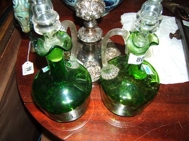 Appraisal: A pair of Victorian green glass ewers of mallet shape