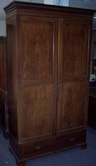 Appraisal: A large Edwardian mahogany wardrobe with drawer beneath cm x