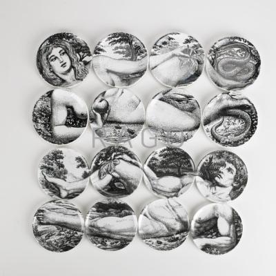 Appraisal: PIERO FORNASETTI Adam and Eve coaster sets Italy th c