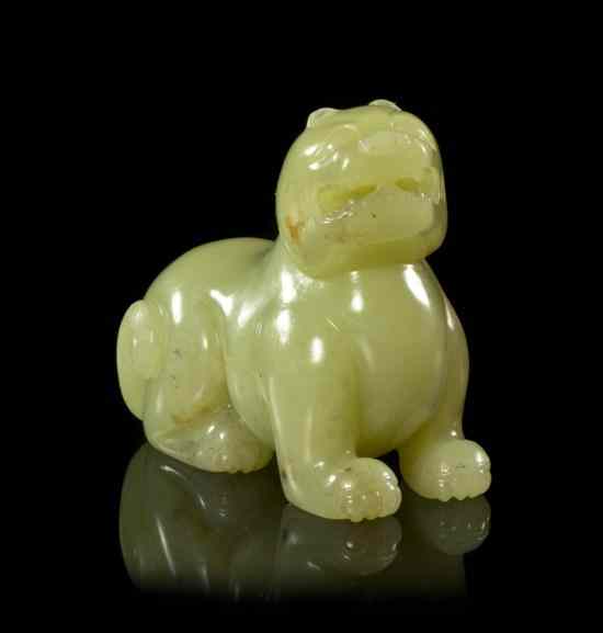 Appraisal: A Yellow Jade Tiger Form Toggle of even colored stone