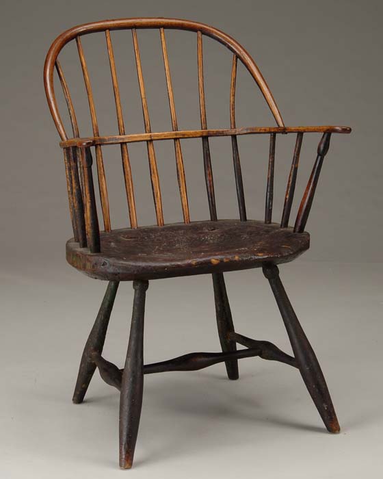 Appraisal: BOW-BACK WINDSOR ARMCHAIR Carved plank seat with carved shaped arms