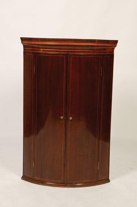 Appraisal: A GEORGE III MAHOGANY BOW FRONTED HANGING CORNER CUPBOARD with