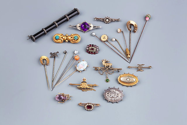 Appraisal: A COLLECTION OF BROOCHES AND STICK PINS to include a