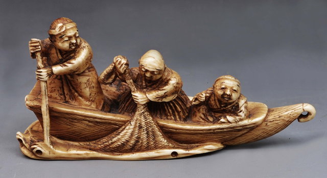 Appraisal: A Japanese ivory okimono of a fishing boatMeiji periodfour figures