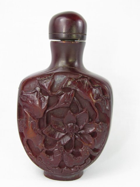 Appraisal: Molded and carved Chinese brown snuff bottle with fish and