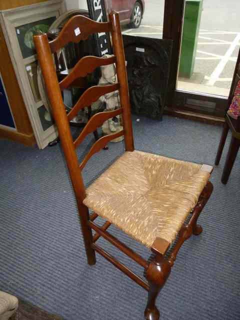 Appraisal: A SET OF FOUR FRUIT WOOD LADDER BACK DINING CHAIRS