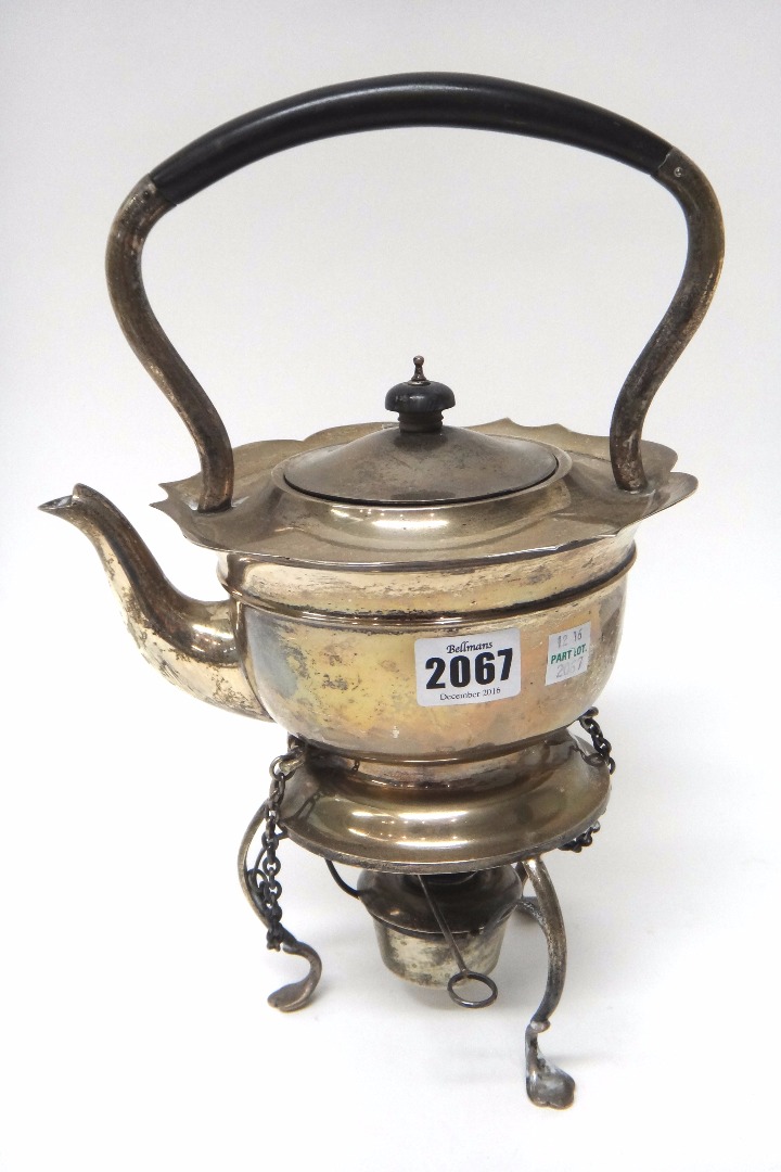 Appraisal: A silver spirit kettle with a silver tripod stand the