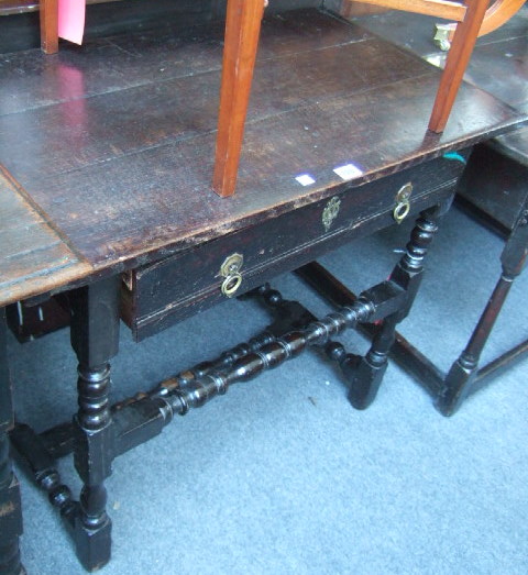 Appraisal: A th century oak side table the triple plank top