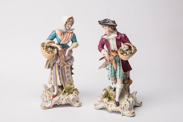 Appraisal: A PAIR OF CONTINENTAL PORCELAIN FIGURINES of a man and