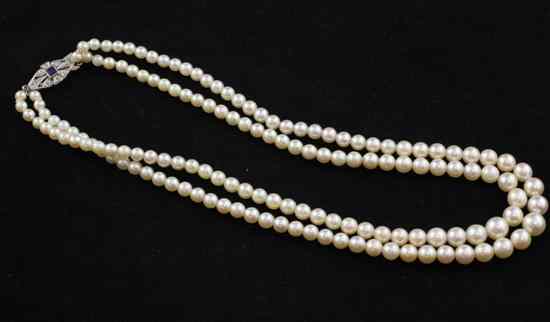 Appraisal: A two strand graduated cultured pearl necklace with sapphire and