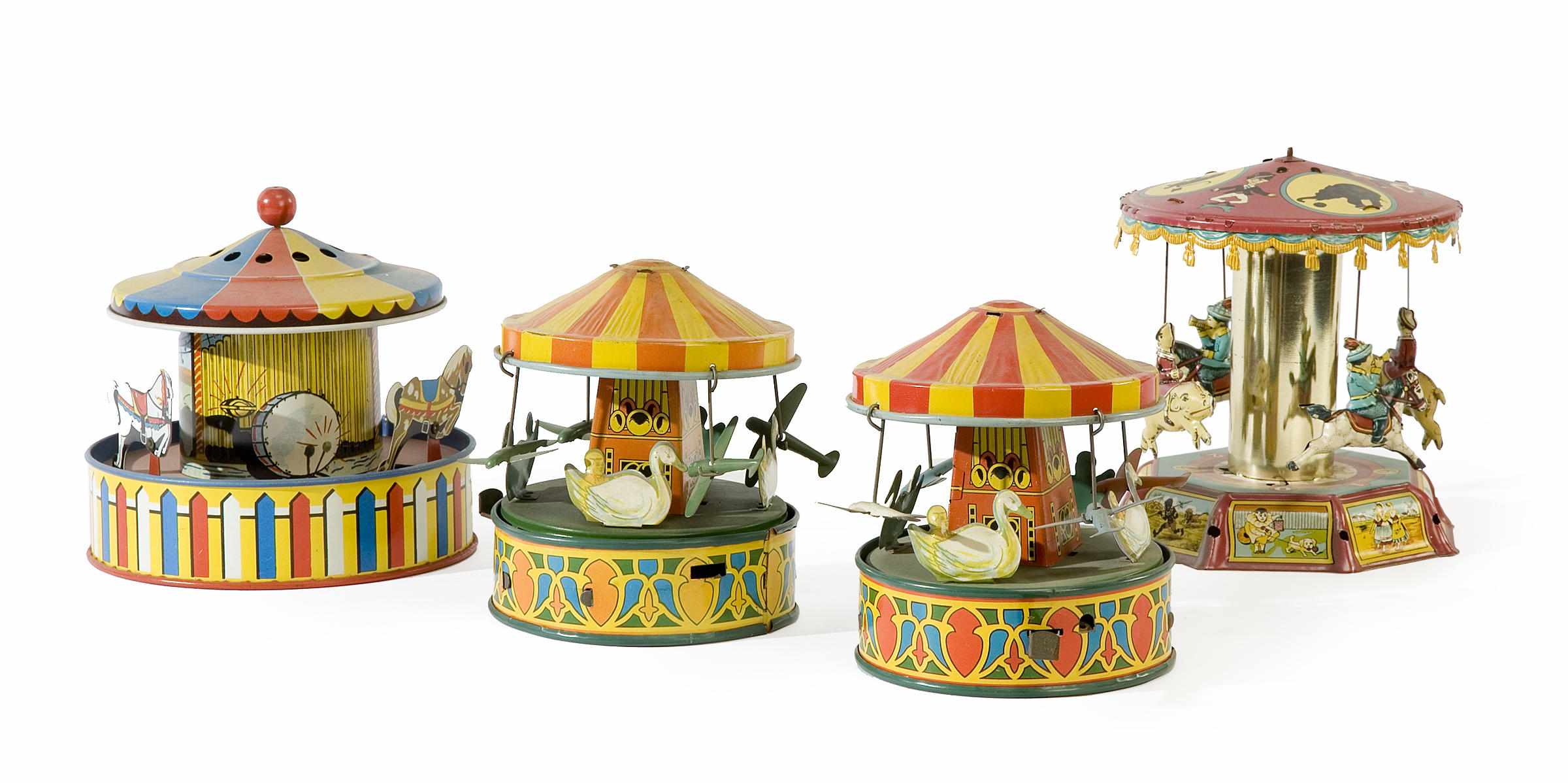 Appraisal: A group of four litho-tin carousel toys first half th