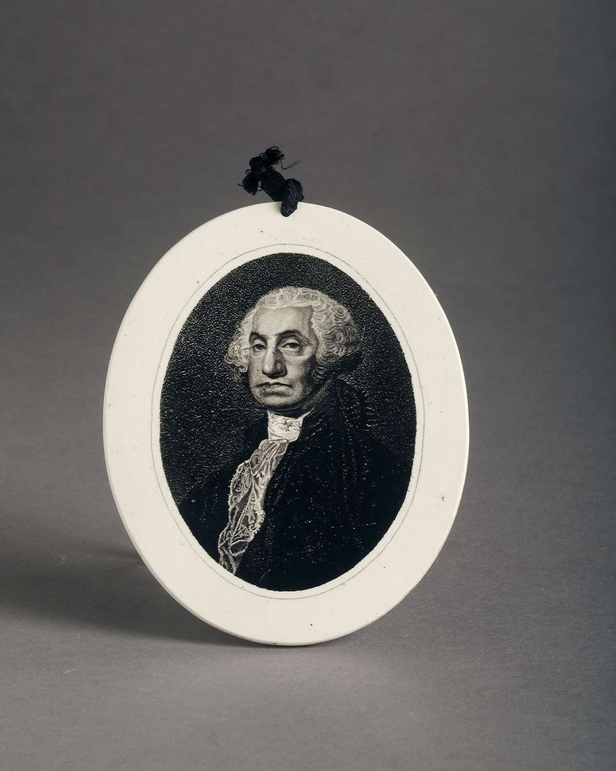 Appraisal: ENGLISH CREAMWARE BLACK TRANSFER-PRINTED OVAL PLAQUE OF GEORGE WASHINGTON HERCULANEUM