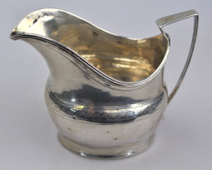 Appraisal: A George III silver helmet cream jug with reeded rim