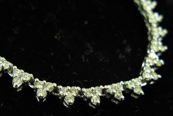 Appraisal: DIAMOND AND FOURTEEN KARAT WHITE GOLD NECKLACE with repeating triangular-shaped