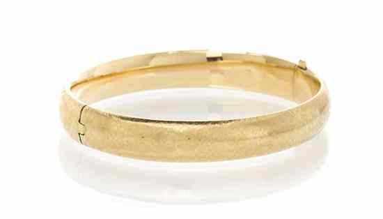 Appraisal: A Karat Yellow Gold Bangle Bracelet with Florentine finish Stamp