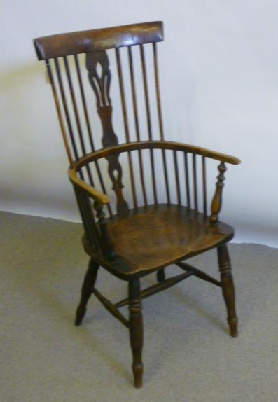 Appraisal: AN ASH AND ELM HIGH COMB BACK WINDSOR ARMCHAIR possibly