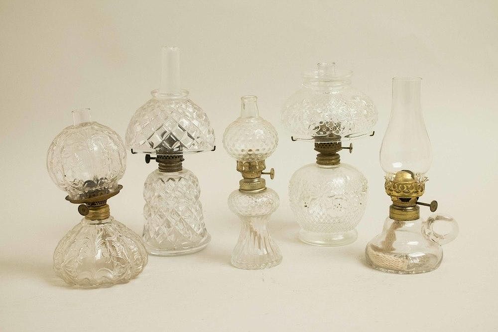 Appraisal: Five Assorted Oil Lamps Five assorted clear glass oil lamps