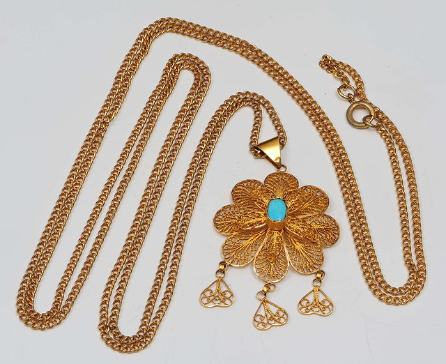 Appraisal: A filigree pendantof stylised form with inset turquoise centre and