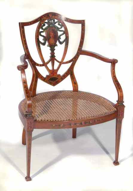 Appraisal: AN EDWARDIAN SHERATON REVIVAL SATINWOOD ARMCHAIR with shield shaped back