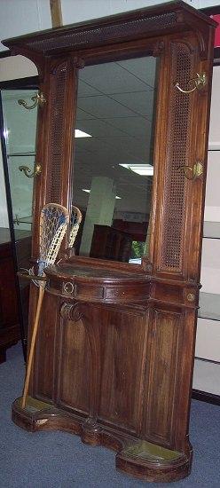 Appraisal: An Edwardian hall stand the mirror flanked by caned panels