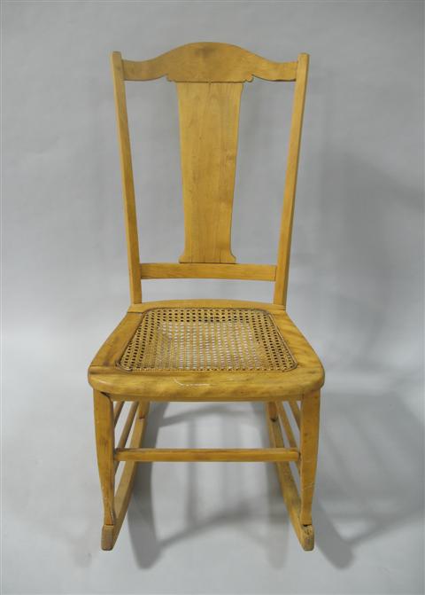 Appraisal: ROCKING CHAIR WITH CANE SEAT Arched back over central back