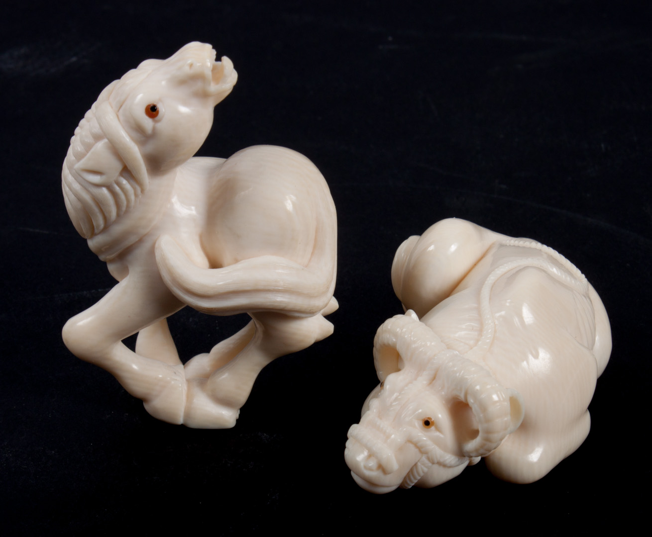 Appraisal: Two Japanese carved ivory figures comprising water buffalo and horse