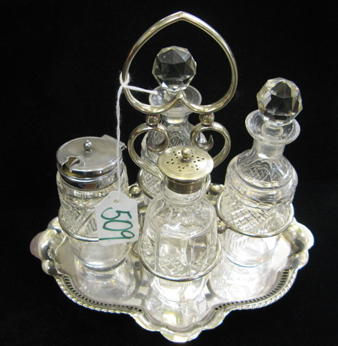 Appraisal: AN ENGLISH CUT CRYSTAL BOTTLE CASTOR SET The plated frame