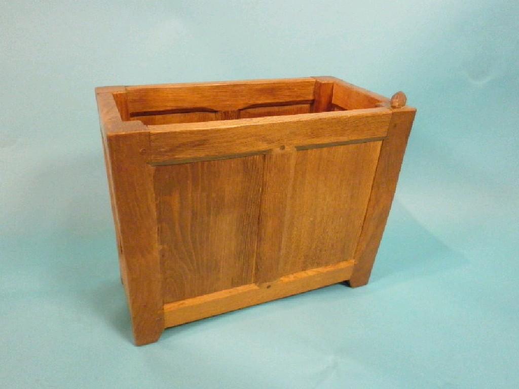 Appraisal: An oak magazine rack by Peter Rabbit Man Heap with