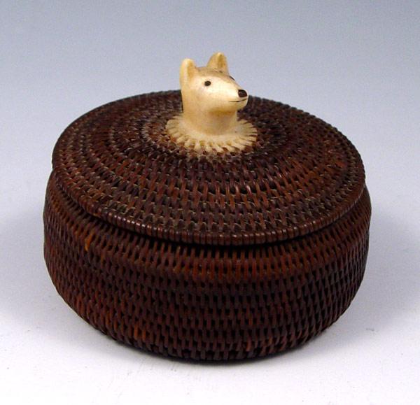 Appraisal: ALASKAN BALEEN BASKET WITH IVORY DOG FINIAL Ivory disc on