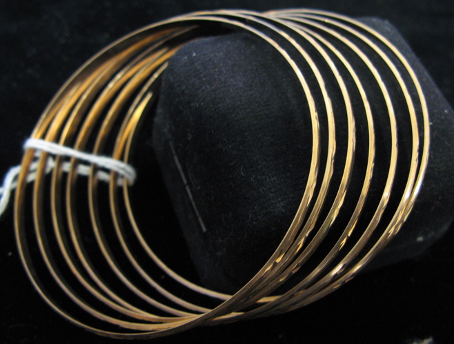 Appraisal: SIX TEN KARAT GOLD BANGLES all round in shape Total