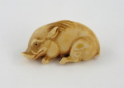 Appraisal: A Japanese ivory netsuke of a recumbent wild boar with