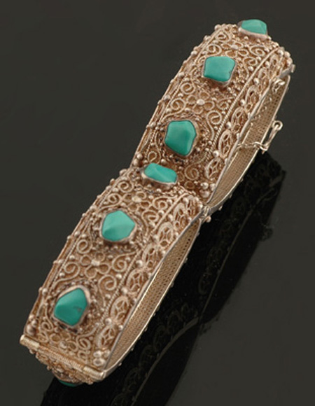 Appraisal: A silver and turquoise bracelet Comprising four curved filligree links