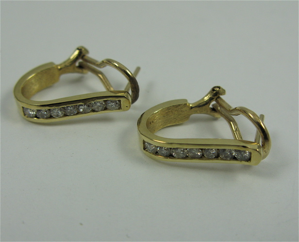 Appraisal: PAIR OF DIAMOND AND K GOLD EARRINGS each with seven